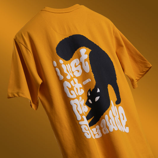 Vibrant yellow oversized 'Cat-Not Tee' floating against a clean backdrop, featuring 'Cobalt Green' branding on the front. The back displays playful screen and puff print artwork with the phrase 'I just cat-not stay awake' and a sleepy black cat graphic. Made from 220 GSM cotton-rich fabric, this tee offers a relaxed unisex fit, bio-washed and gold-finished for a soft, premium feel. Perfect for casual wear, lounging, or adding a humorous touch to any outfit.