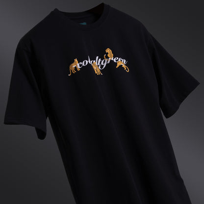 Classic black oversized 'Leopard Tee' floating against a matching backdrop, featuring a striking screen and puff print of a leopard and roses on both the front and back. The premium 220 GSM cotton-rich fabric ensures durability and comfort, while the bio-washed and gold-finished treatment provides a soft, luxurious feel. The relaxed, unisex fit offers a flattering look for all body types, making it the perfect choice for those seeking bold style with a touch of elegance.
