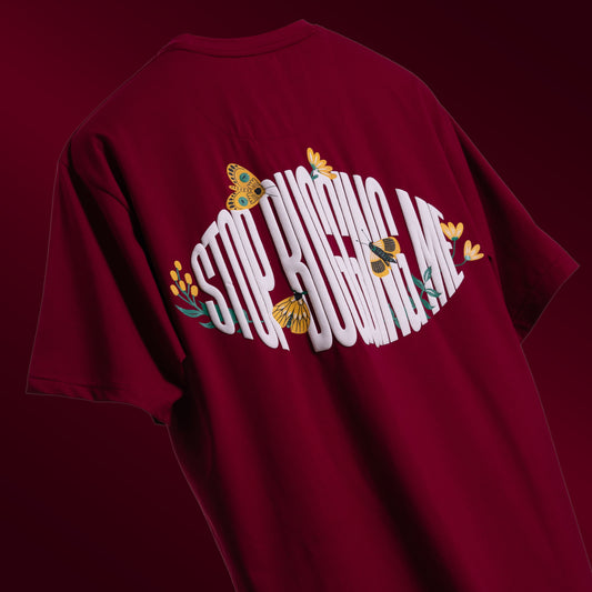 Bold maroon oversized 'Stop Bugging Me Tee' floating against a matching backdrop, featuring 'Cobalt Green' branding on the front. The back displays the playful 'STOP BUGGING ME' phrase with quirky bug graphics in screen and puff print. Made from 220 GSM cotton-rich fabric with bio-washed and gold-finished treatment for a soft, premium feel. The oversized, unisex design ensures comfort and style for all, perfect for casual wear with a sassy attitude.